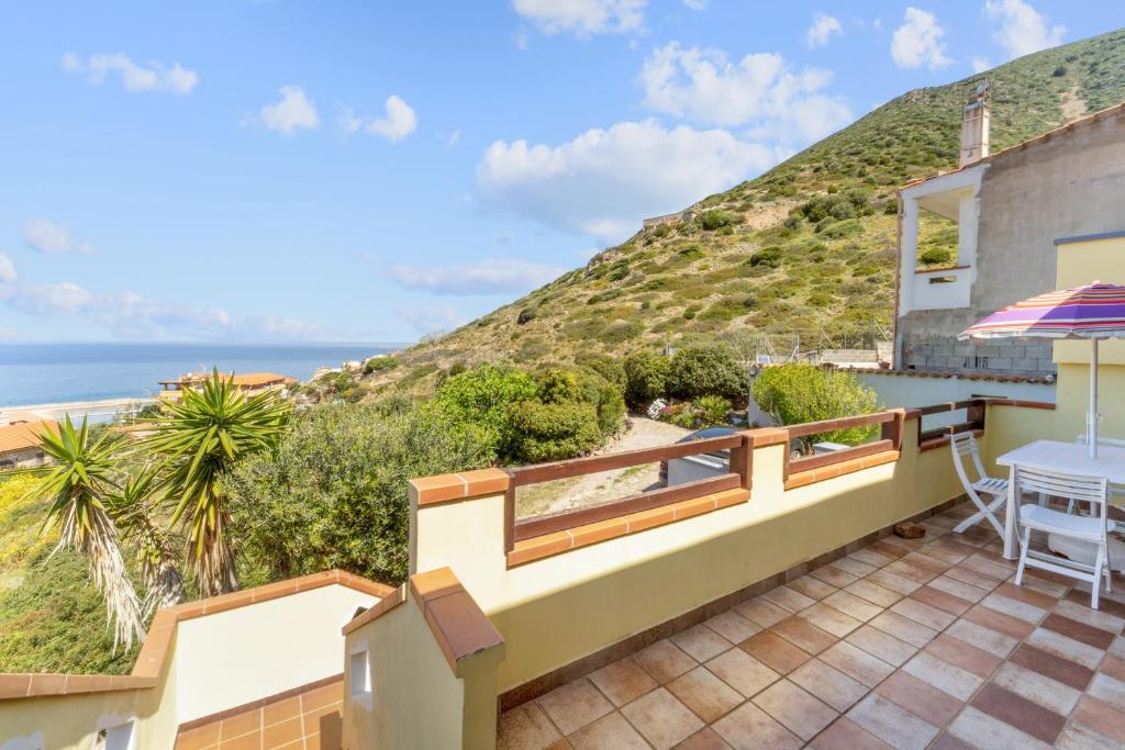 a house with a balcony with a view of the ocean at La Bella Vista in Buggerru
