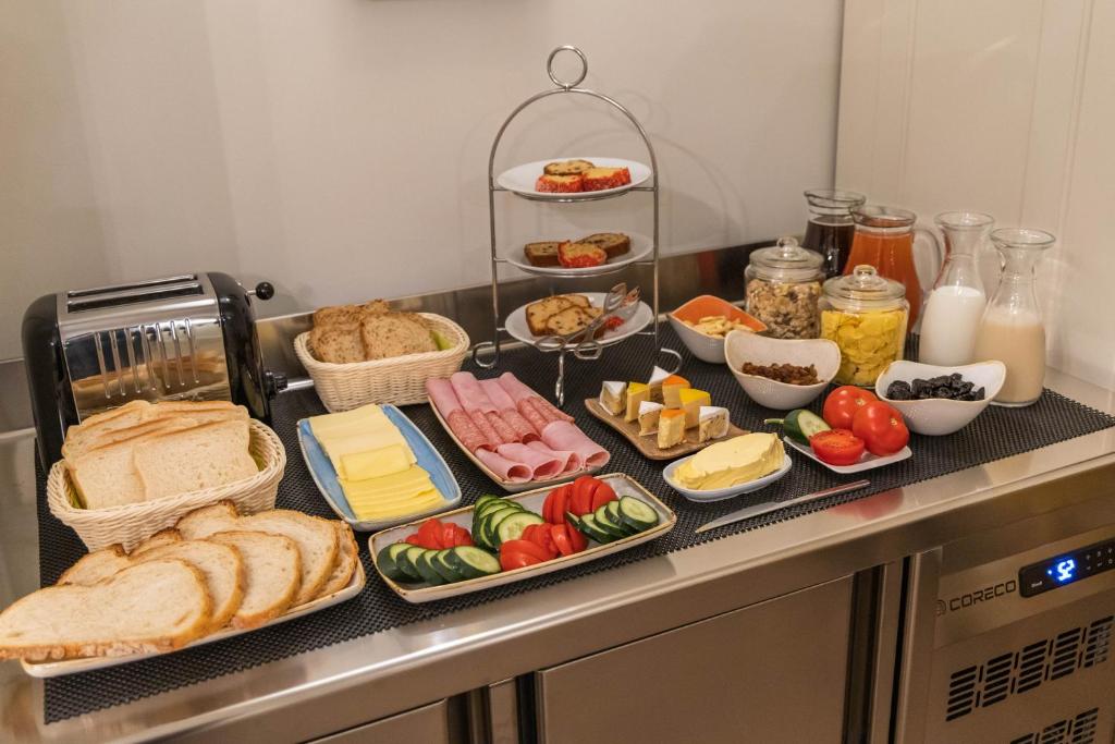 a table with different types of food on it at Belle Boutique in Sliema