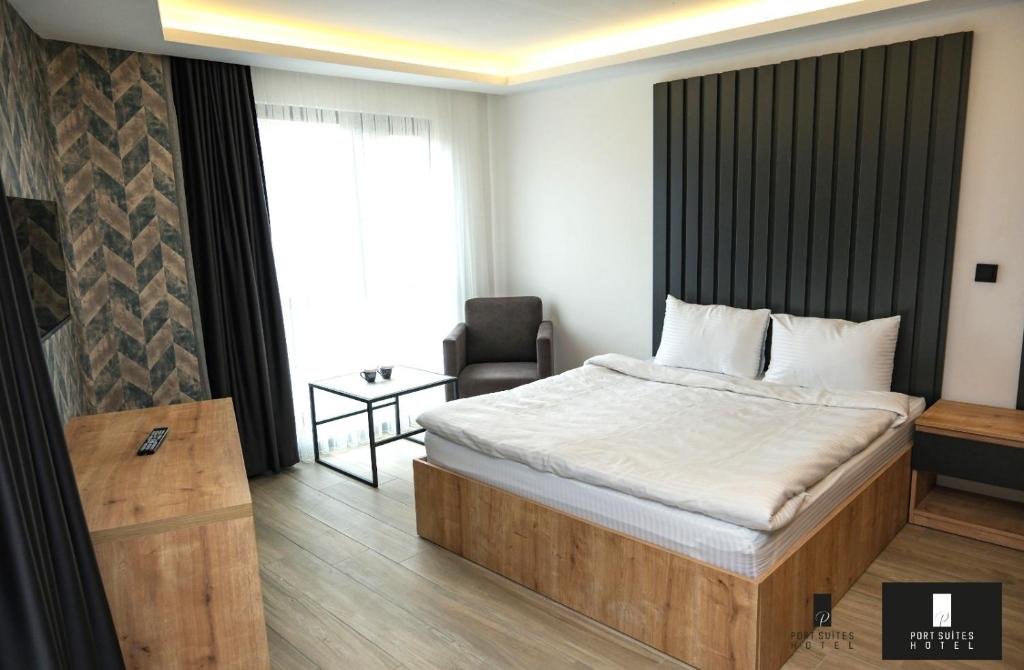 a hotel room with a bed and a chair at Port Suites Hotel in Bursa