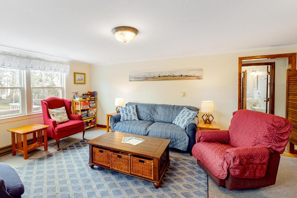 a living room with a couch and two chairs at Nauset Beach Dream in Orleans