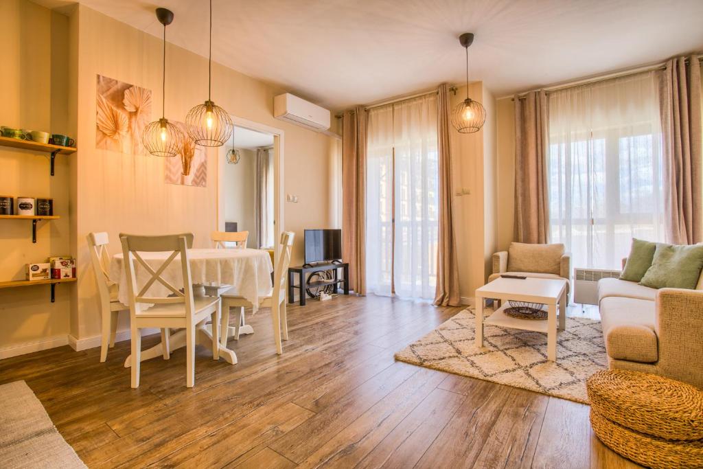 a living room with a table and a dining room at Cozy 2BD Apartment in Bansko in Bansko