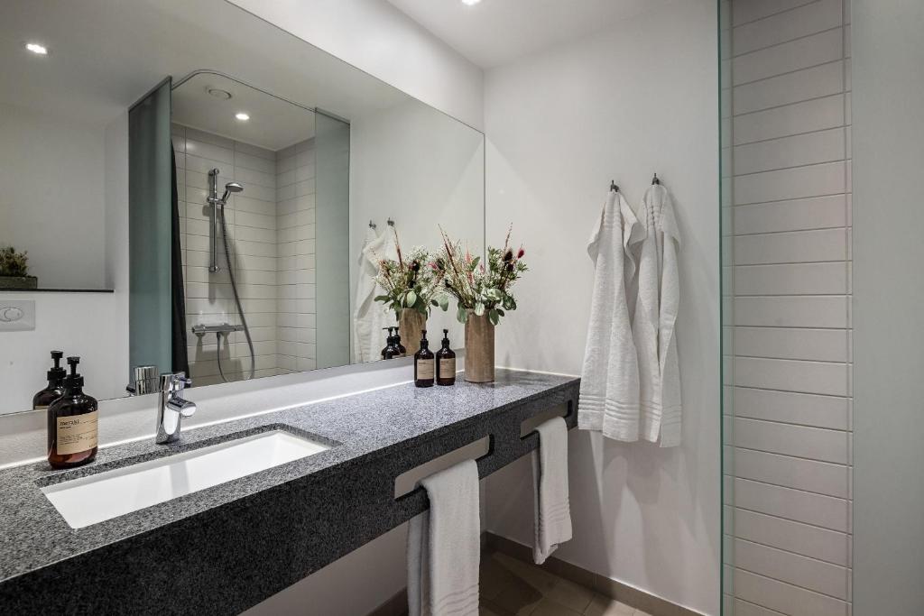 a bathroom with a sink and a mirror at Aalborg Airport Hotel in Aalborg
