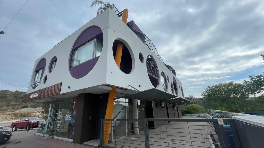 a house shaped building on the side of a road at Círculos del Lago in Villa Carlos Paz