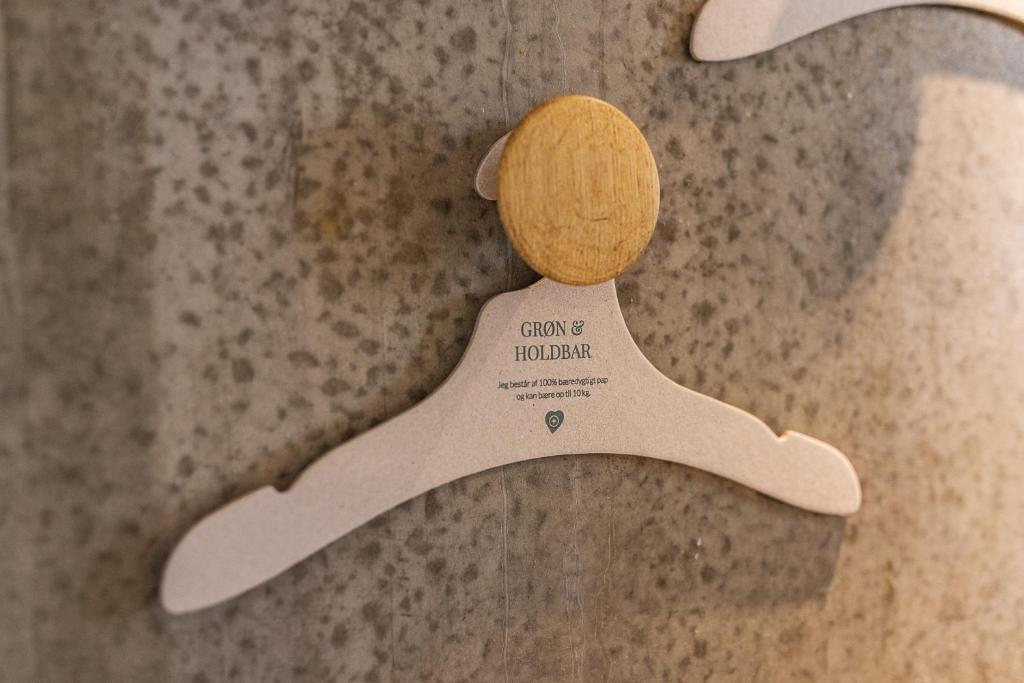 a wooden tennis racket with a wooden ball on it at Aalborg Airport Hotel in Aalborg