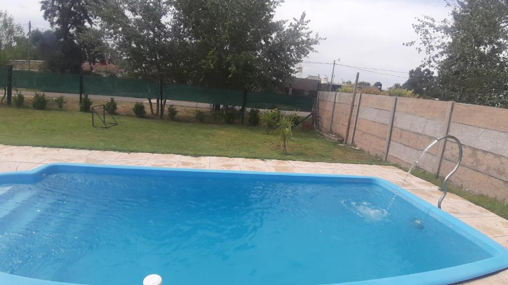 a large blue swimming pool in a backyard at Casaquinta en Funes in Funes