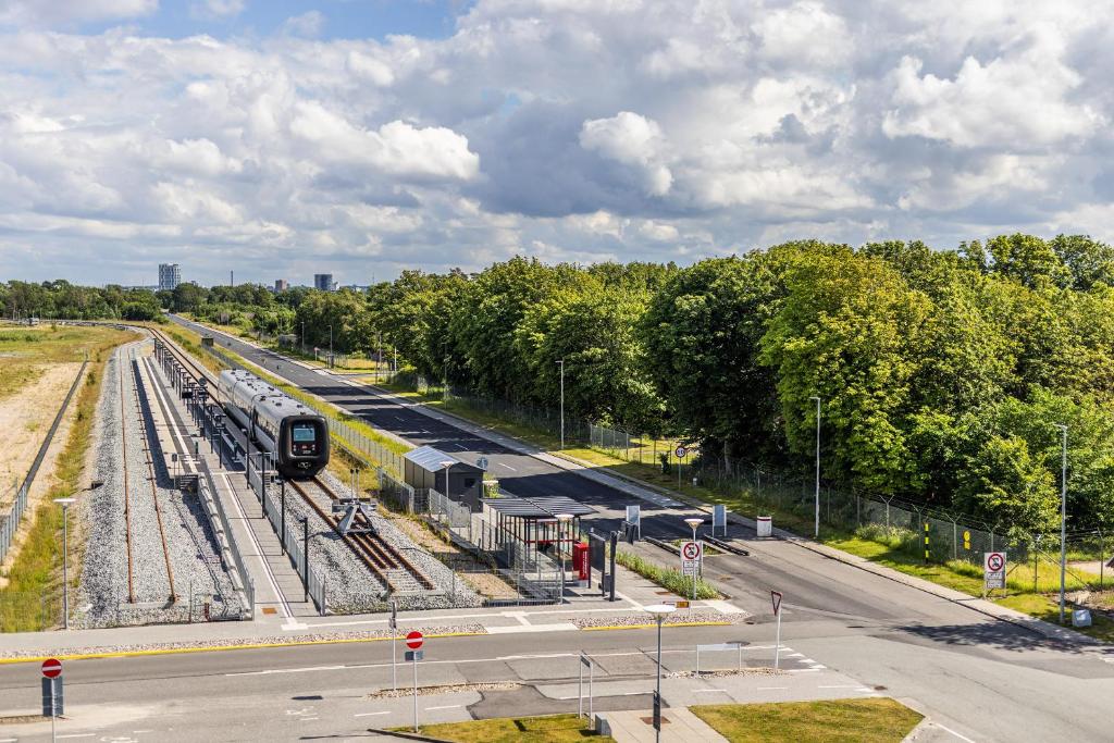 an overhead view of a train station with a train at Aalborg Airport Hotel in Aalborg