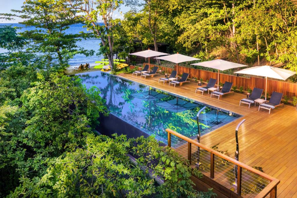 an overhead view of a swimming pool with chairs and a deck at Secret Bay in Portsmouth