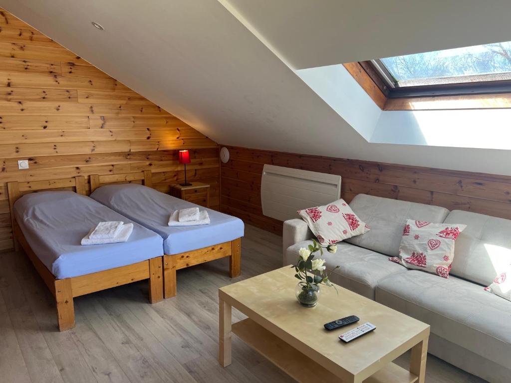 a living room with a couch and a table at Les Chalets de Montclar Azur et Neige in Montclar