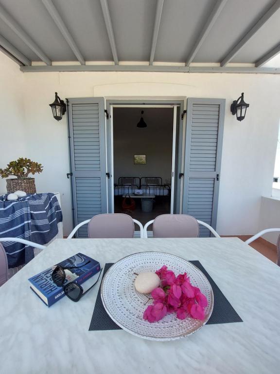 a plate with a egg and flowers on a table at Paros Reppas House "Livadia" in Parikia