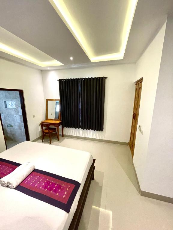 Postel nebo postele na pokoji v ubytování DIMUWA Ubud