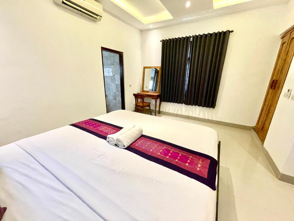 Postel nebo postele na pokoji v ubytování DIMUWA Ubud