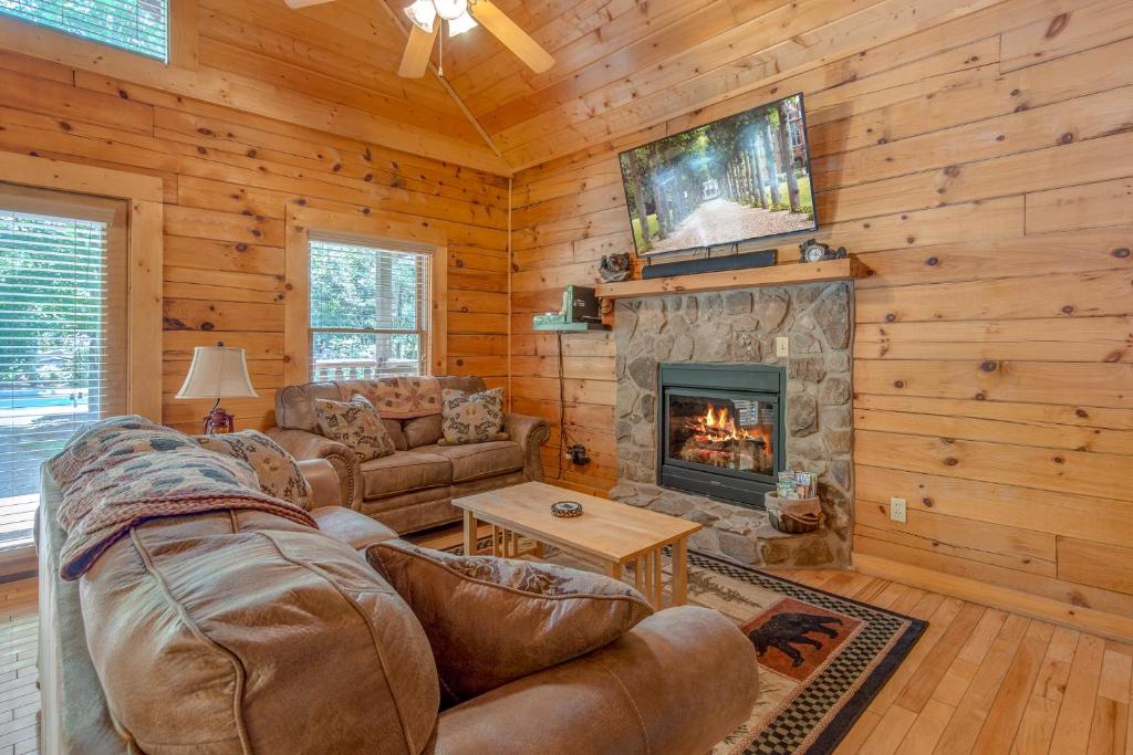 a living room with a couch and a fireplace at A Mountain Paradise, 2 Bedrooms, Sleeps 6, Pool Access, Hot Tub, Pool Table in Pigeon Forge