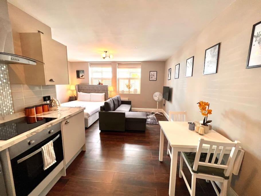 a kitchen and living room with a couch and a table at Lovely Studio close to Brighton Station in Brighton & Hove