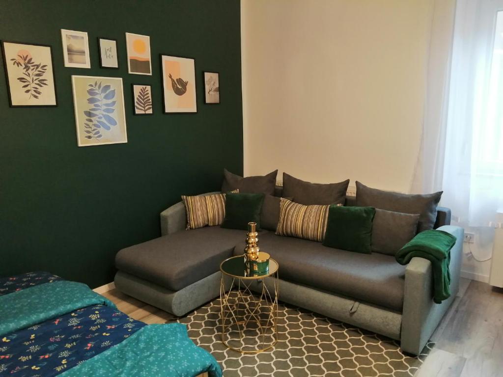 a living room with a couch and a table at Hanna apartman in Szeged