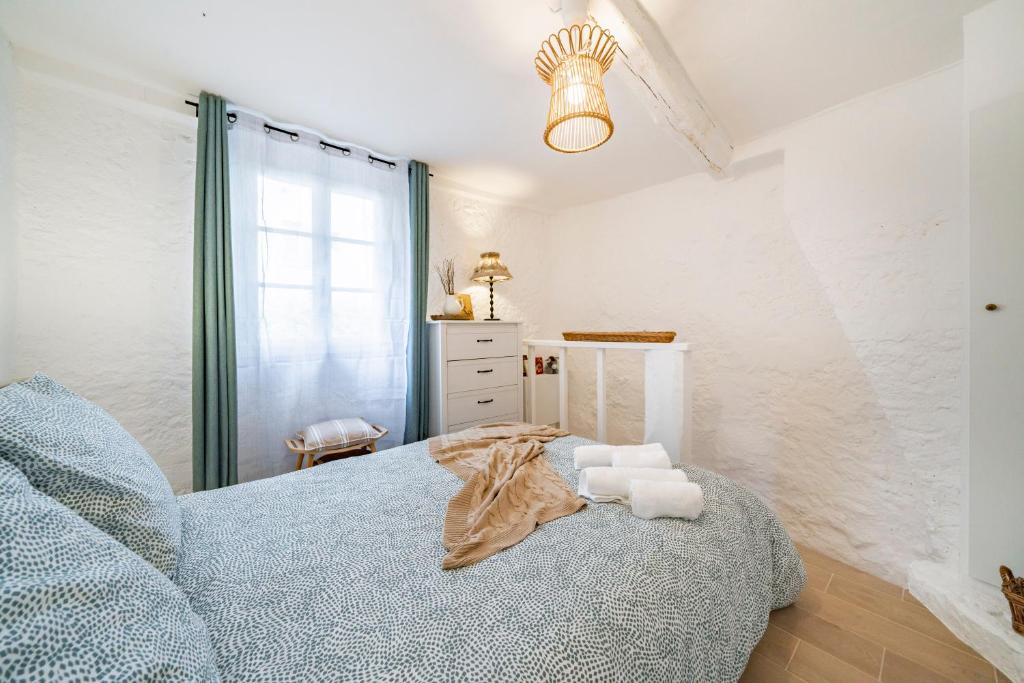 Łóżko lub łóżka w pokoju w obiekcie La Maison de l'Âne