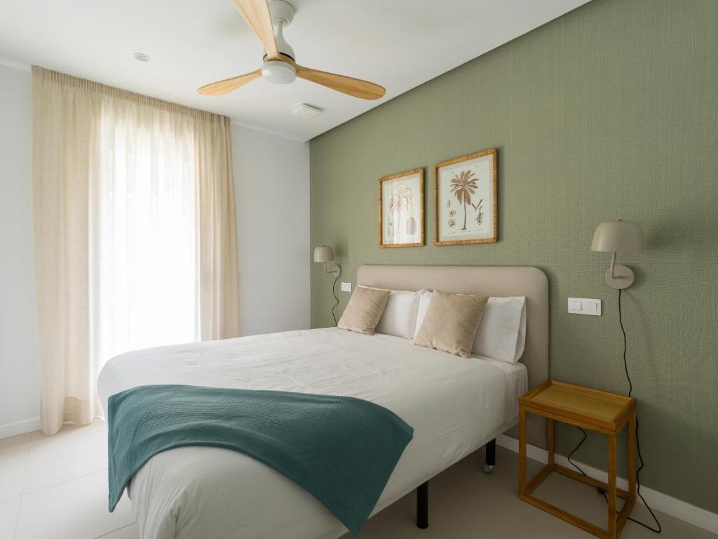a bedroom with a bed and a ceiling fan at Royal Suites in Las Palmas de Gran Canaria