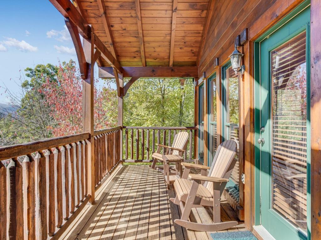 a porch with rocking chairs and a wooden ceiling at Heaven's View, 2 Bedrooms, Sleeps 10, Hot Tub, Pool Table, Arcade, Jacuzzi in Gatlinburg