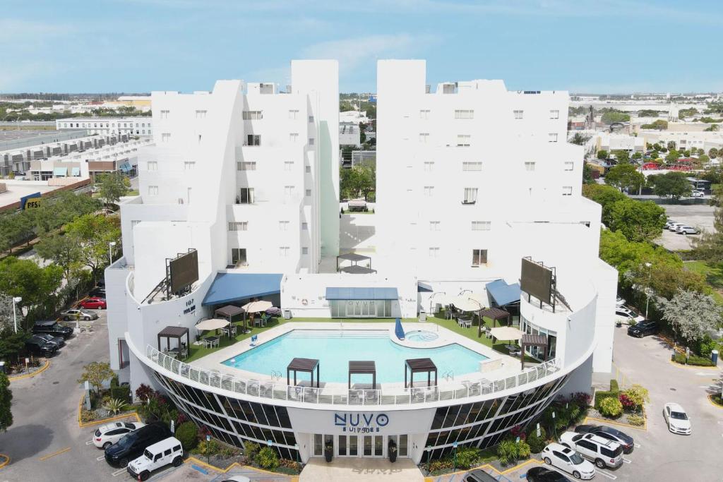 an aerial view of a building with a swimming pool at Nuvo Suites Hotel - Miami Doral in Miami