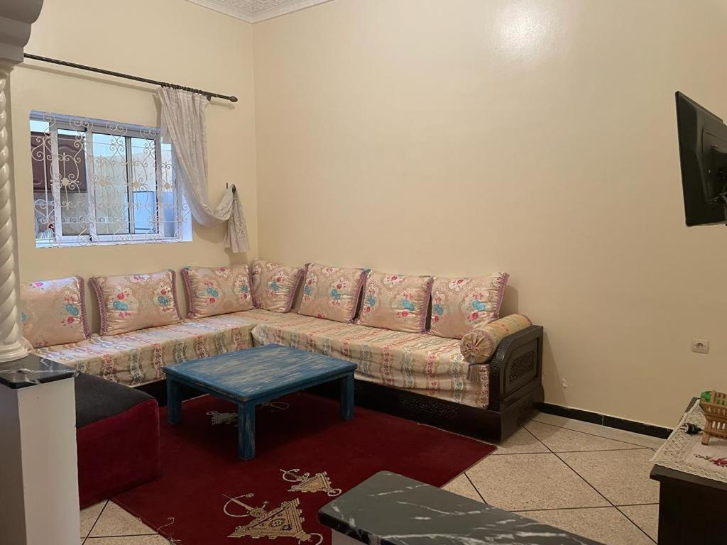a living room with a couch and a table at Holiday house in Sale