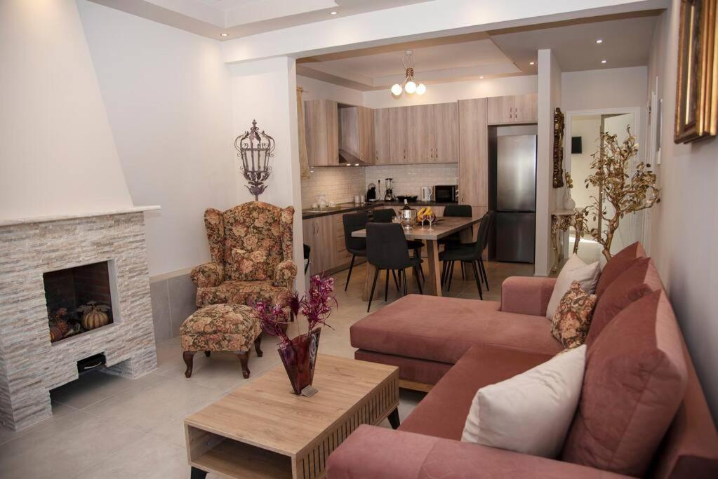a living room with a couch and a fireplace at Mariangelas House in Kos