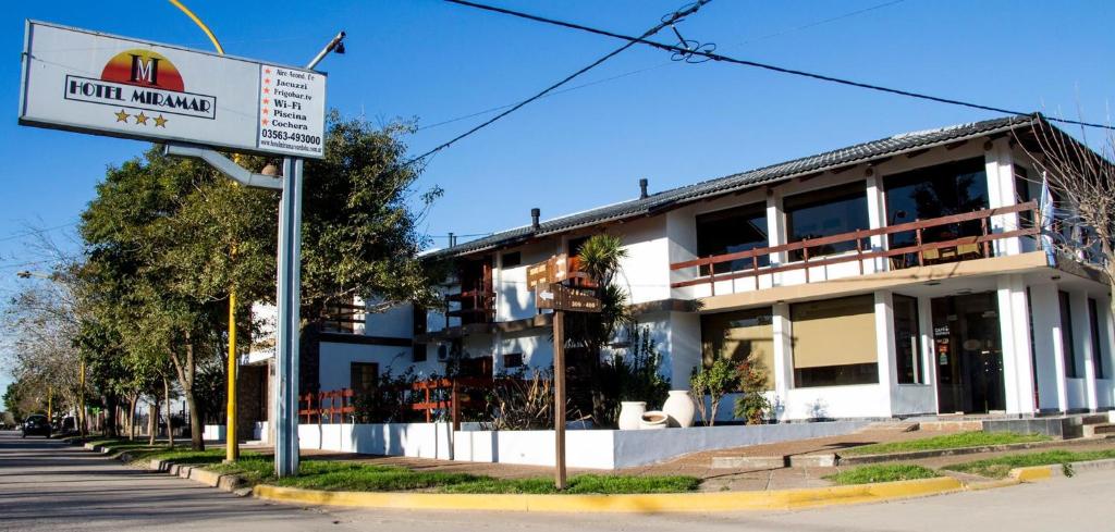 a hotel building with a sign in front of it at HOTEL MIRAMAR in Miramar