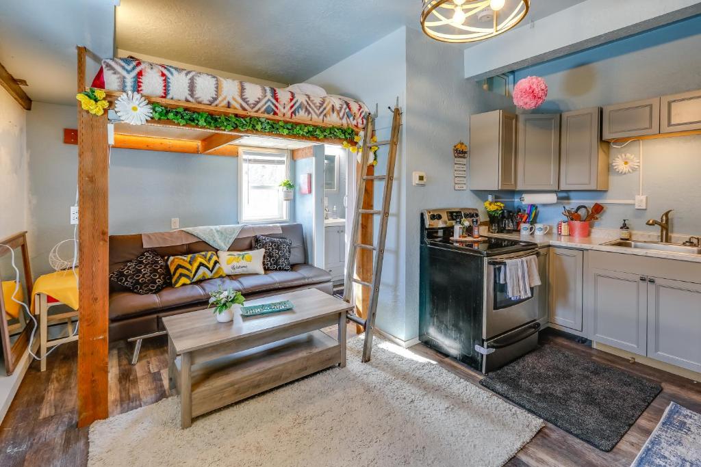 a living room with a bunk bed and a kitchen at Fairbanks Vacation Rental Studio Near Downtown! in Fairbanks