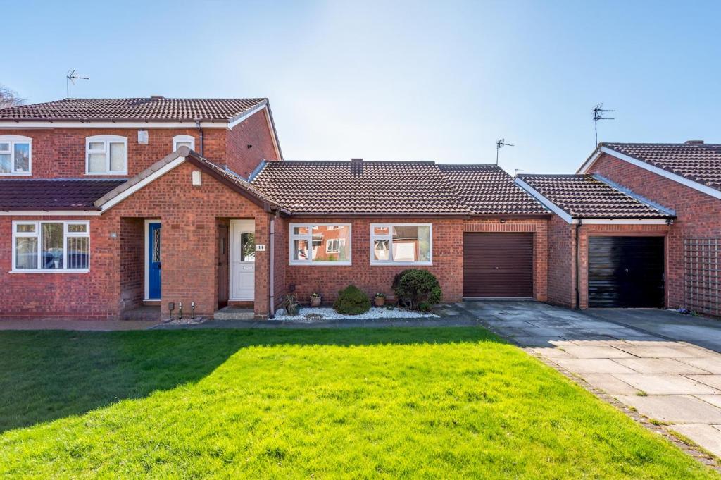 a brick house with a garage and a yard at Peaceful Home Away From Home I Pass The Keys in York