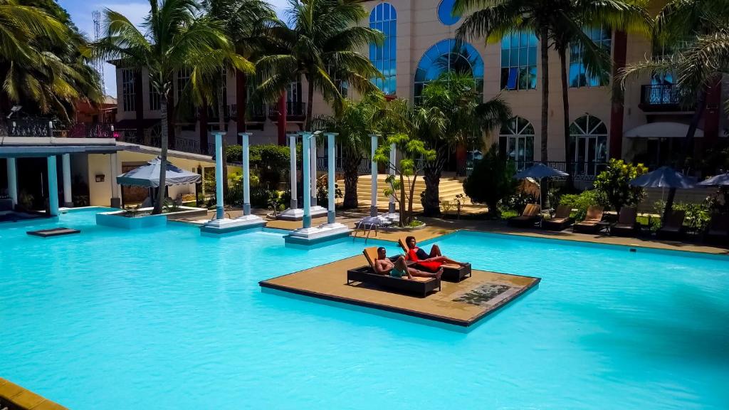 2 personnes dormant dans une piscine d'un hôtel dans l'établissement Le Grand Hôtel Diego, à Diego Suarez