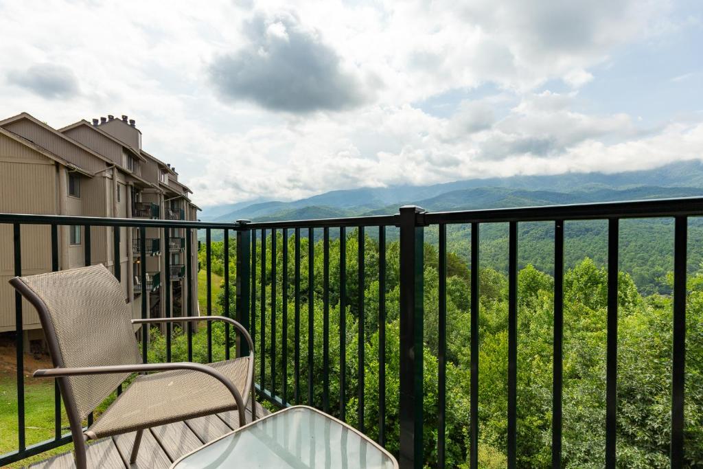 a chair on a balcony with a view of the mountains at Deer Ridge Mountain Resort C102 in Gatlinburg