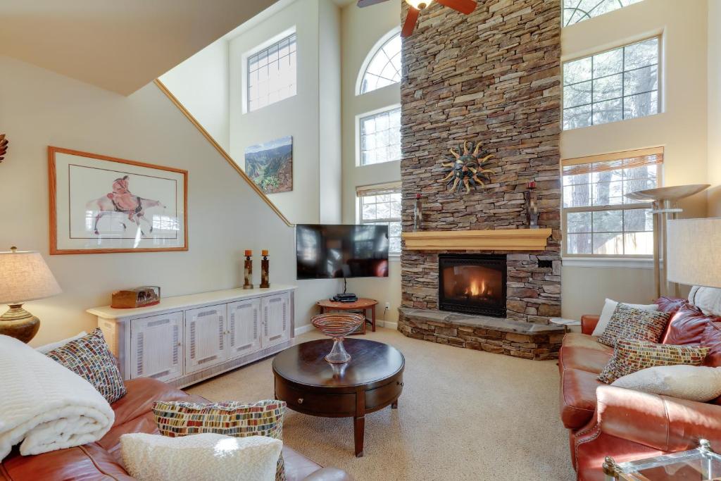 a living room with a fireplace and a tv at Cozy Arizona Retreat with Fireplace, Patio and Grill! in Flagstaff