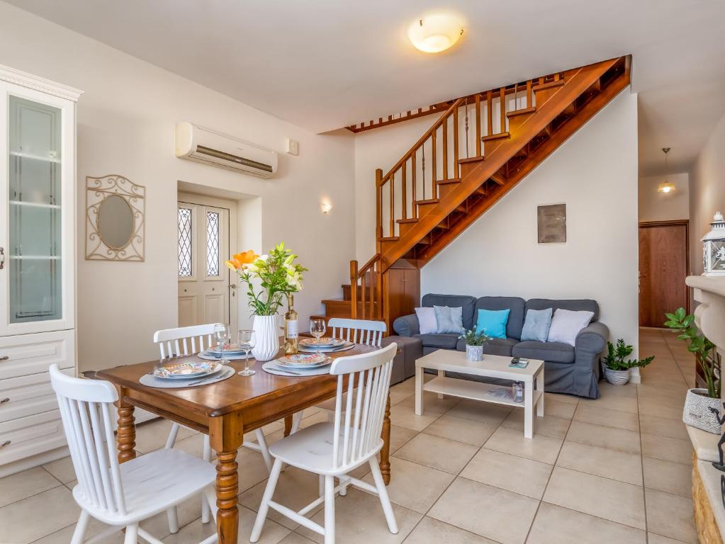 a living room with a table and chairs and a couch at Casteli Stone Residence in Kissamos