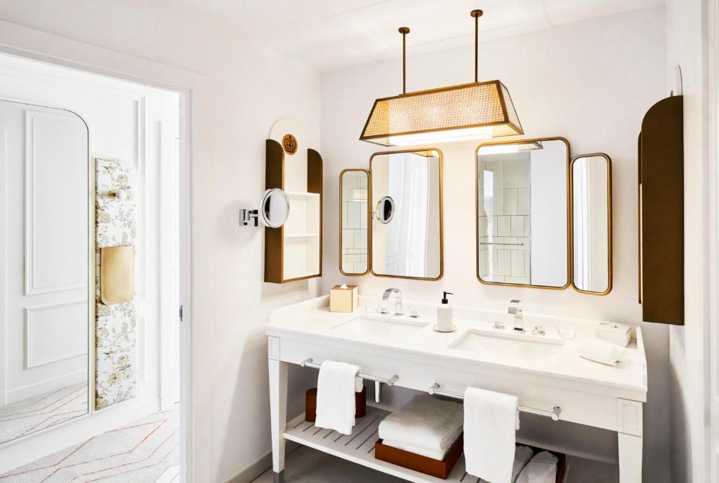 a bathroom with a sink and a mirror at Carlton Cannes, a Regent Hotel in Cannes