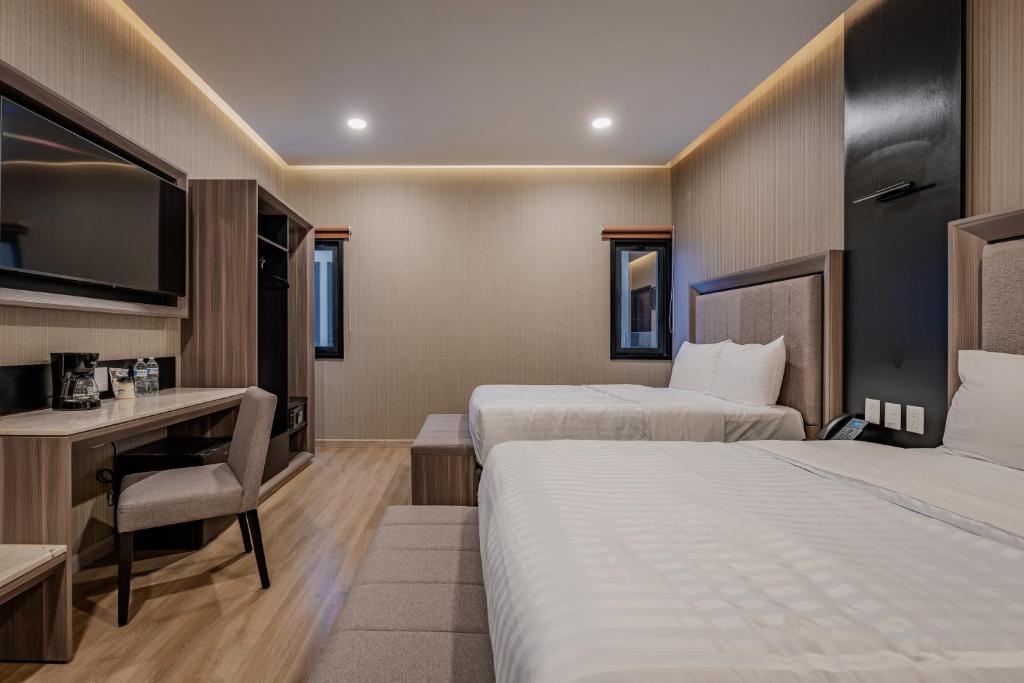 Postel nebo postele na pokoji v ubytování Hotel Kavia Premium - Paseo Montejo