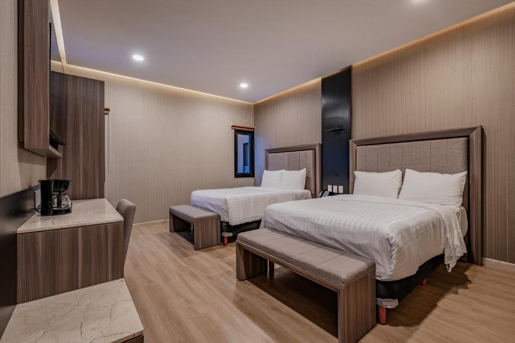 Postel nebo postele na pokoji v ubytování Hotel Kavia Premium - Paseo Montejo