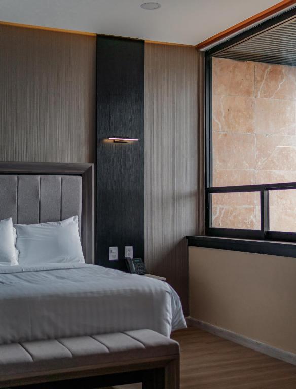 Postel nebo postele na pokoji v ubytování Hotel Kavia Premium - Paseo Montejo