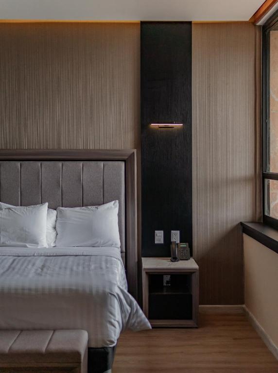 Postel nebo postele na pokoji v ubytování Hotel Kavia Premium - Paseo Montejo