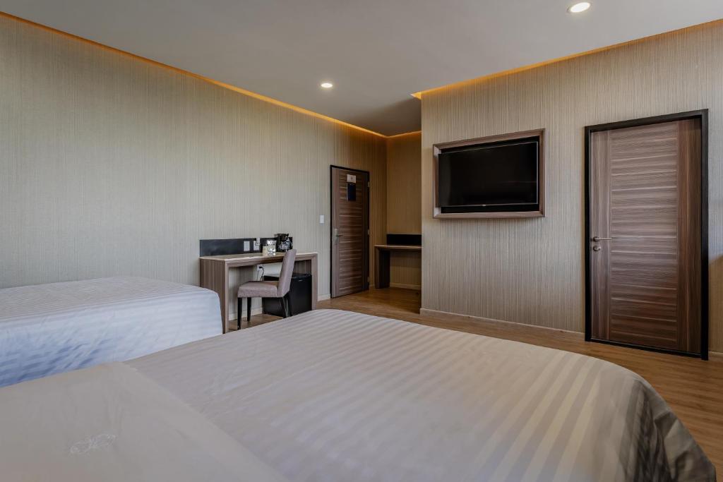 Postel nebo postele na pokoji v ubytování Hotel Kavia Premium - Paseo Montejo