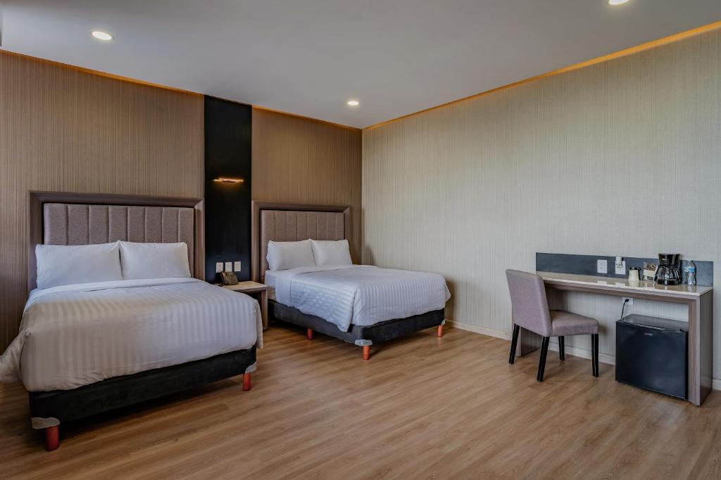 Postel nebo postele na pokoji v ubytování Hotel Kavia Premium - Paseo Montejo