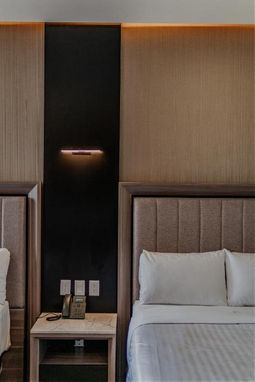 Postel nebo postele na pokoji v ubytování Hotel Kavia Premium - Paseo Montejo