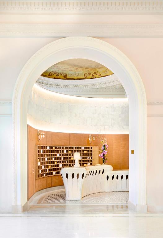 an archway in a white room with a white table at Carlton Cannes, a Regent Hotel in Cannes