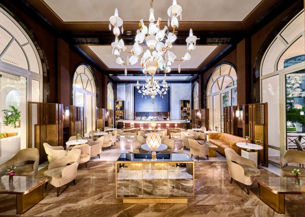 a lobby of a hotel with a chandelier at Carlton Cannes, a Regent Hotel in Cannes