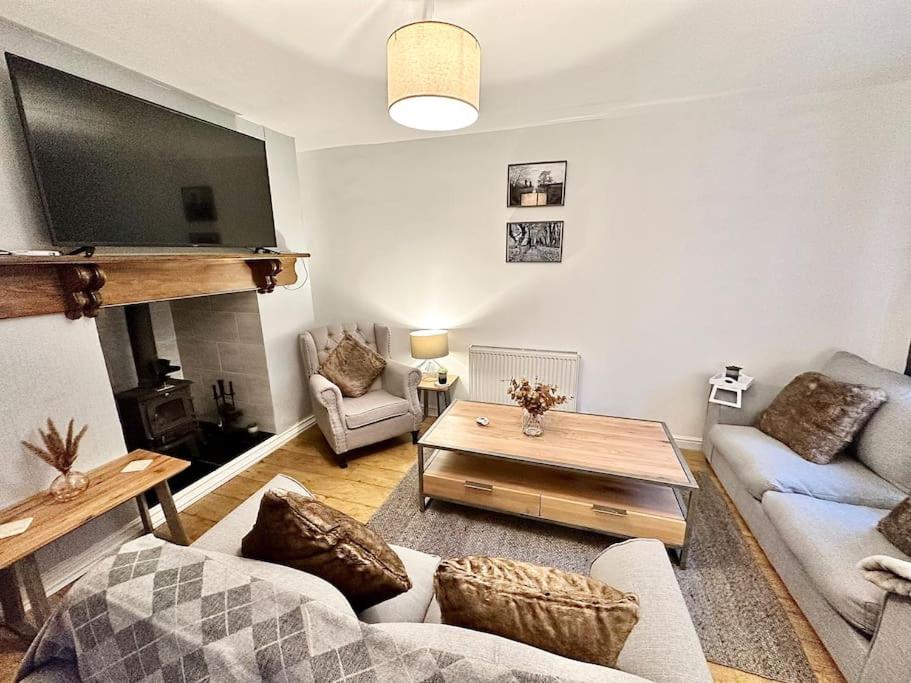 a living room with a couch and a coffee table at Cottage,Cinema Room,Log Burner in Blaenavon