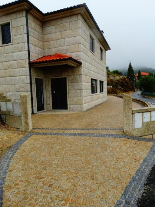 a large stone building with a large driveway at Casa Malagueira in Fafião
