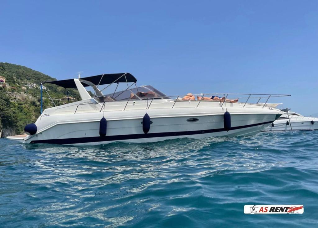 a white boat in the water on the ocean at AIR OF SEA ON BOAT in Salerno