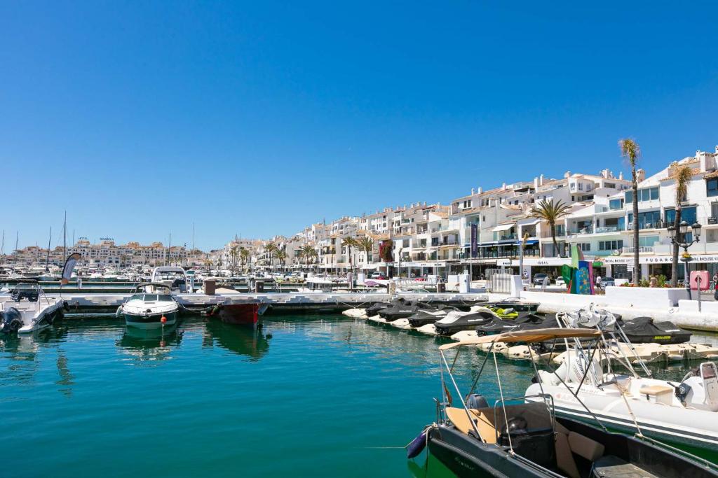 a group of boats docked in a harbor with buildings at Puerto Banus, Marina Banus, 2BR, 2BTH, pool, parking, Marbella, 1J in Marbella