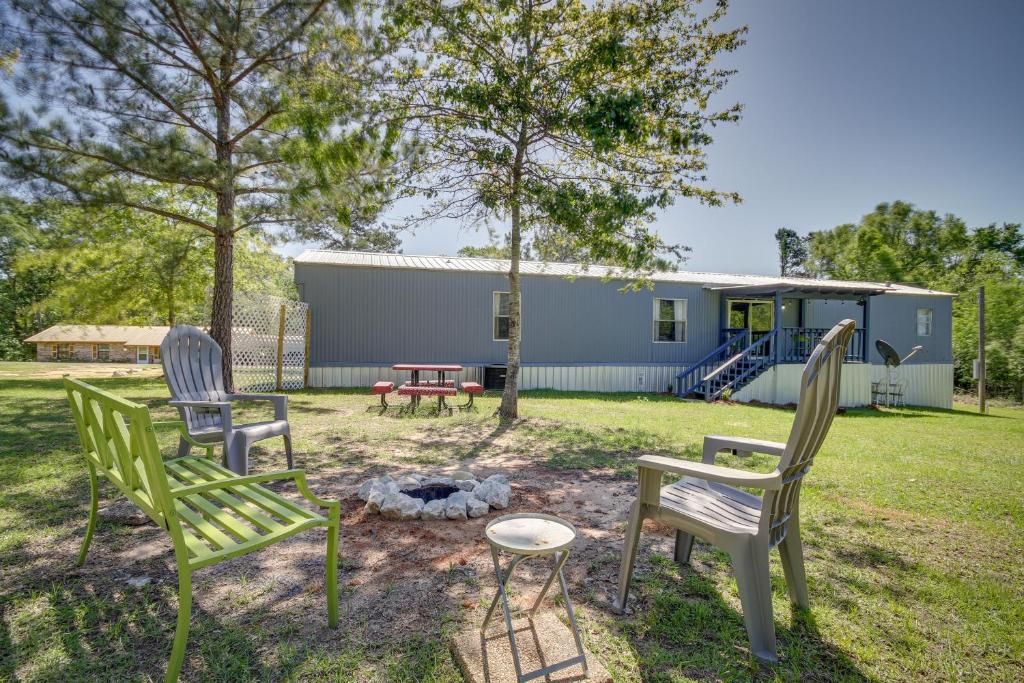 a group of chairs sitting in a yard with a fire pit at Fire Pit and Deck Peaceful Silver Creek Retreat in Prentiss