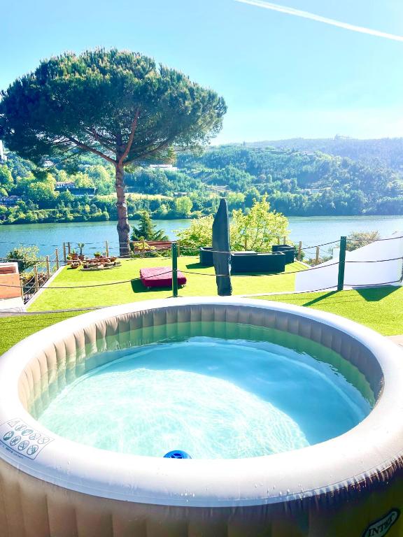 a large hot tub with a view of a lake at Douro in Melres