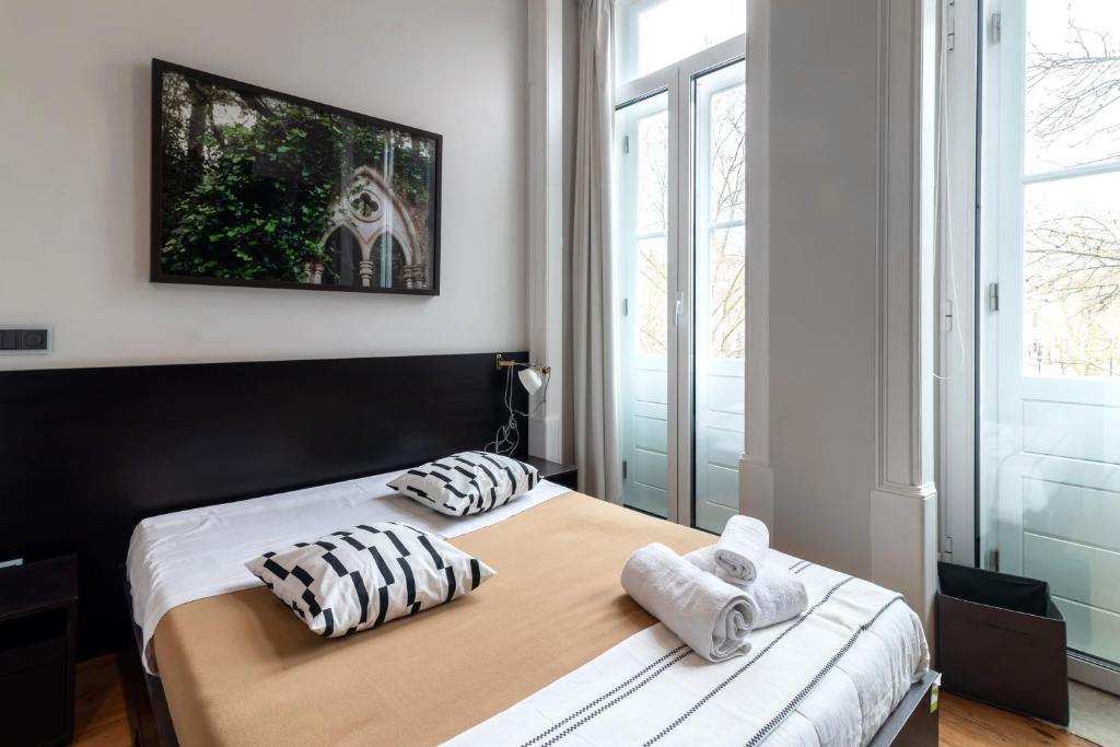 - une chambre avec 2 lits et des serviettes dans l'établissement Despertar Saudade, à Coimbra