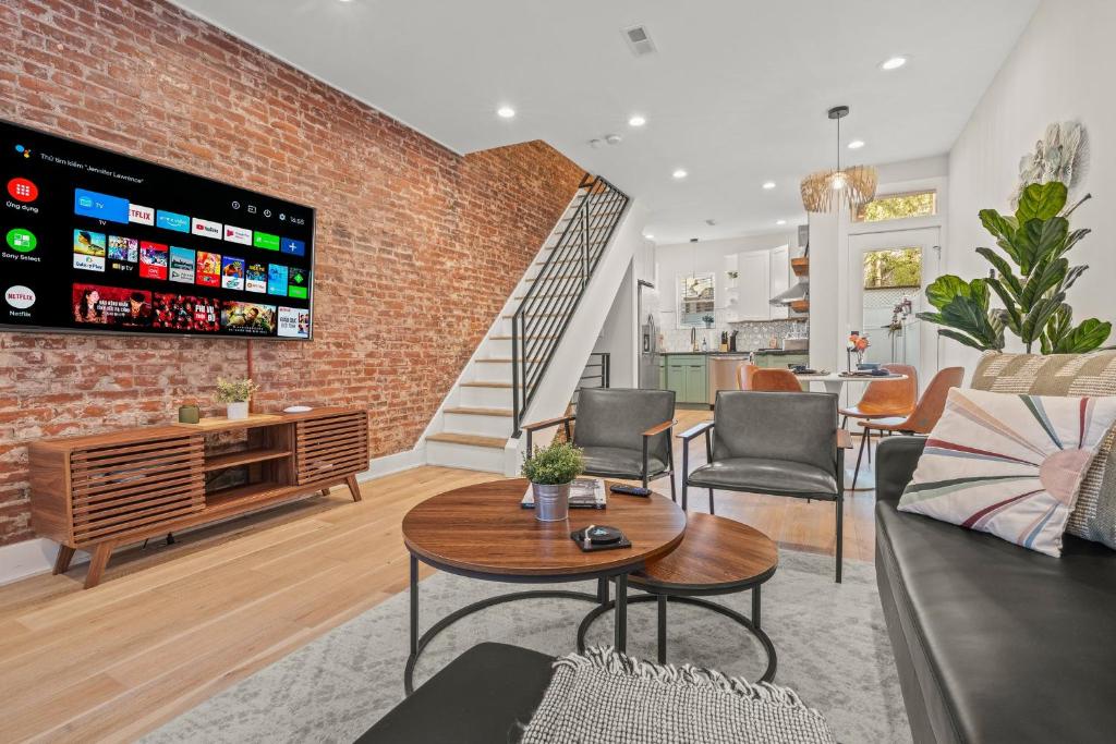 a living room with a brick wall at Kid-Friendly Fishtown Family Retreat with Game Room in Philadelphia