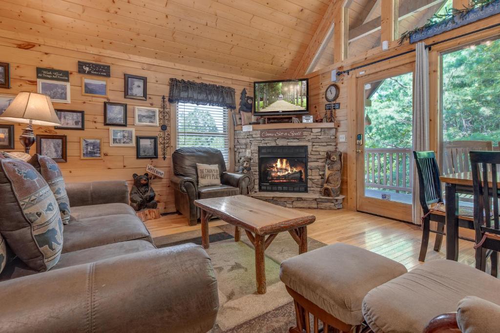 a living room with a fireplace and a tv at Americana, 2 Bedrooms, Sleeps 6, View, Pool Access, Hot Tub, Fireplace in Gatlinburg